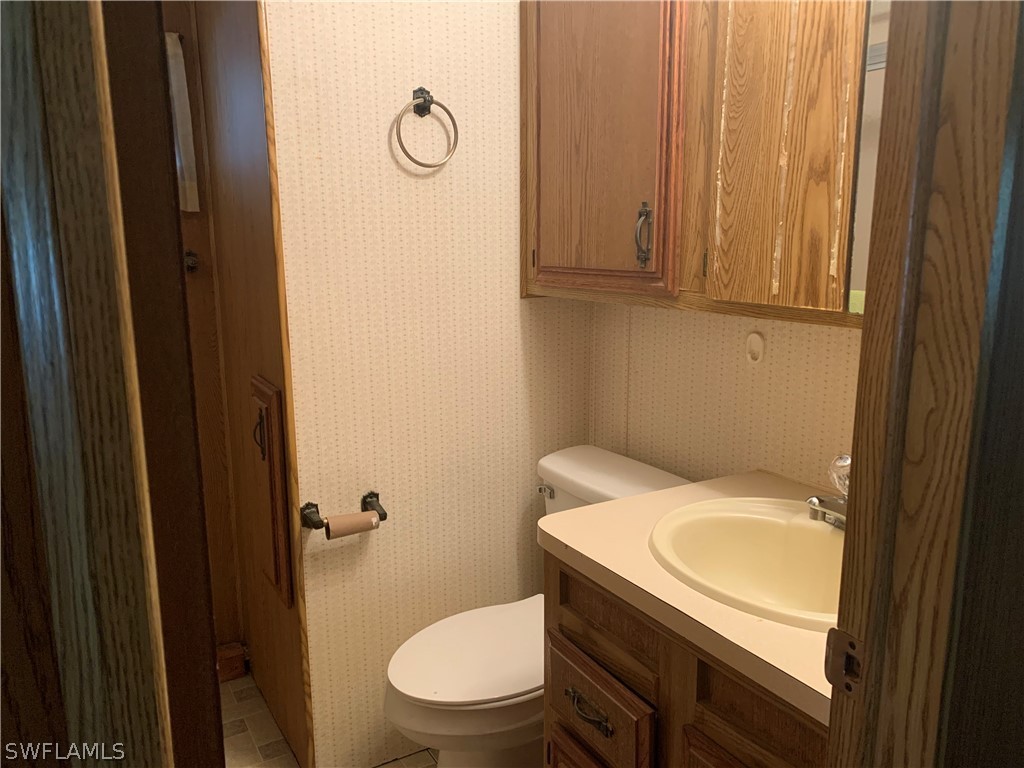 19681 Summerlin Road, Unit 195 Fort Myers, FL 33908 - Photo 4 of 12 a bathroom with a granite countertop toilet and a sink