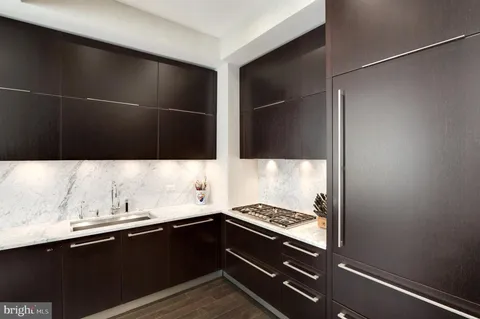 a kitchen with a sink and stainless steel appliances