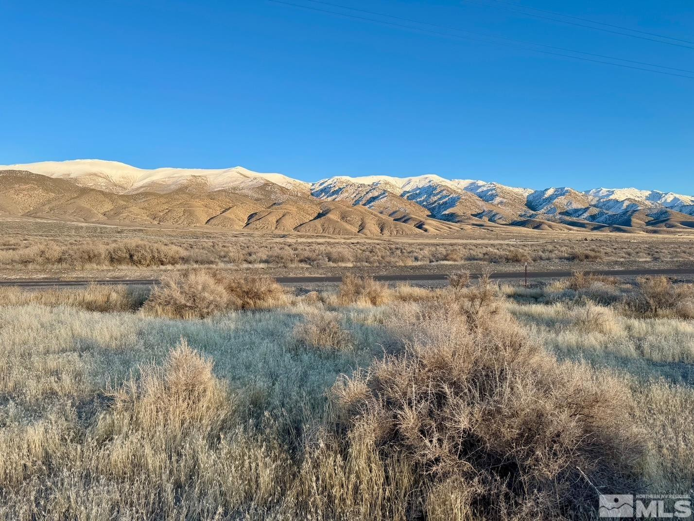 a view of a large mountain with a mountain in the background