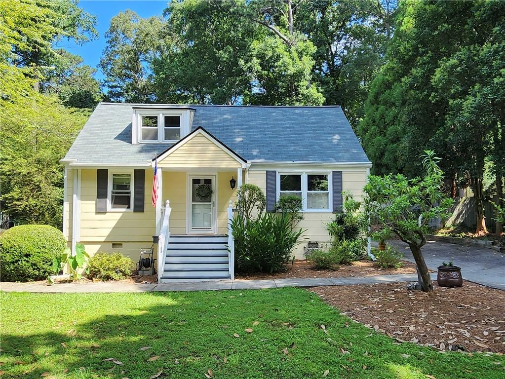 a front view of a house with a garden