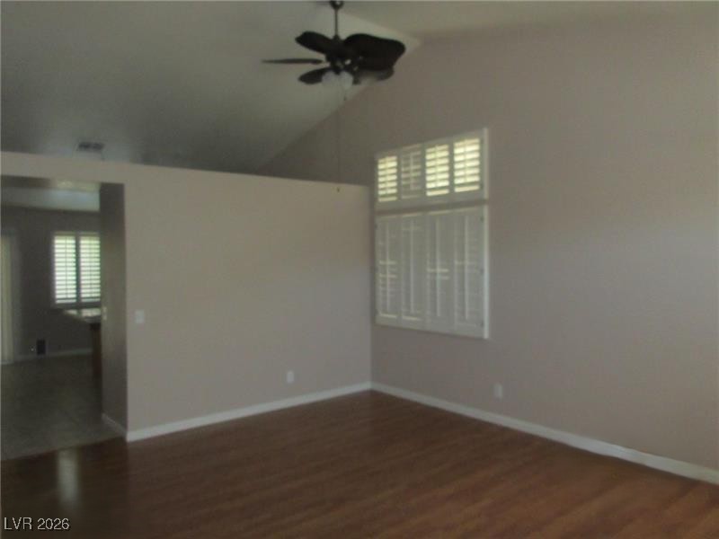 171 Enloe Street Henderson, NV 89074 - Photo 6 of 12 Dining room with vaulted ceiling, laminate floors, and a ceiling fan