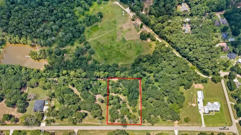 a view of a green field with lots of trees