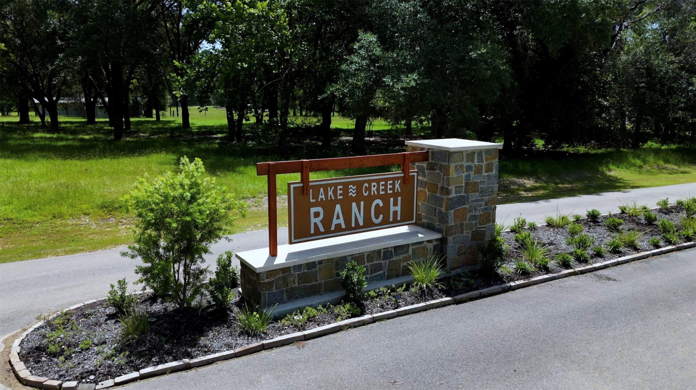 2448 Old Ranch Road Montgomery, TX 77316 - Photo 9 of 10 a sign board with a bench plants