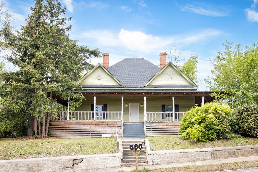2113 Summerville Road Phenix City, AL 36867 - Photo 1 of 37 a front view of a house with a garden and plants