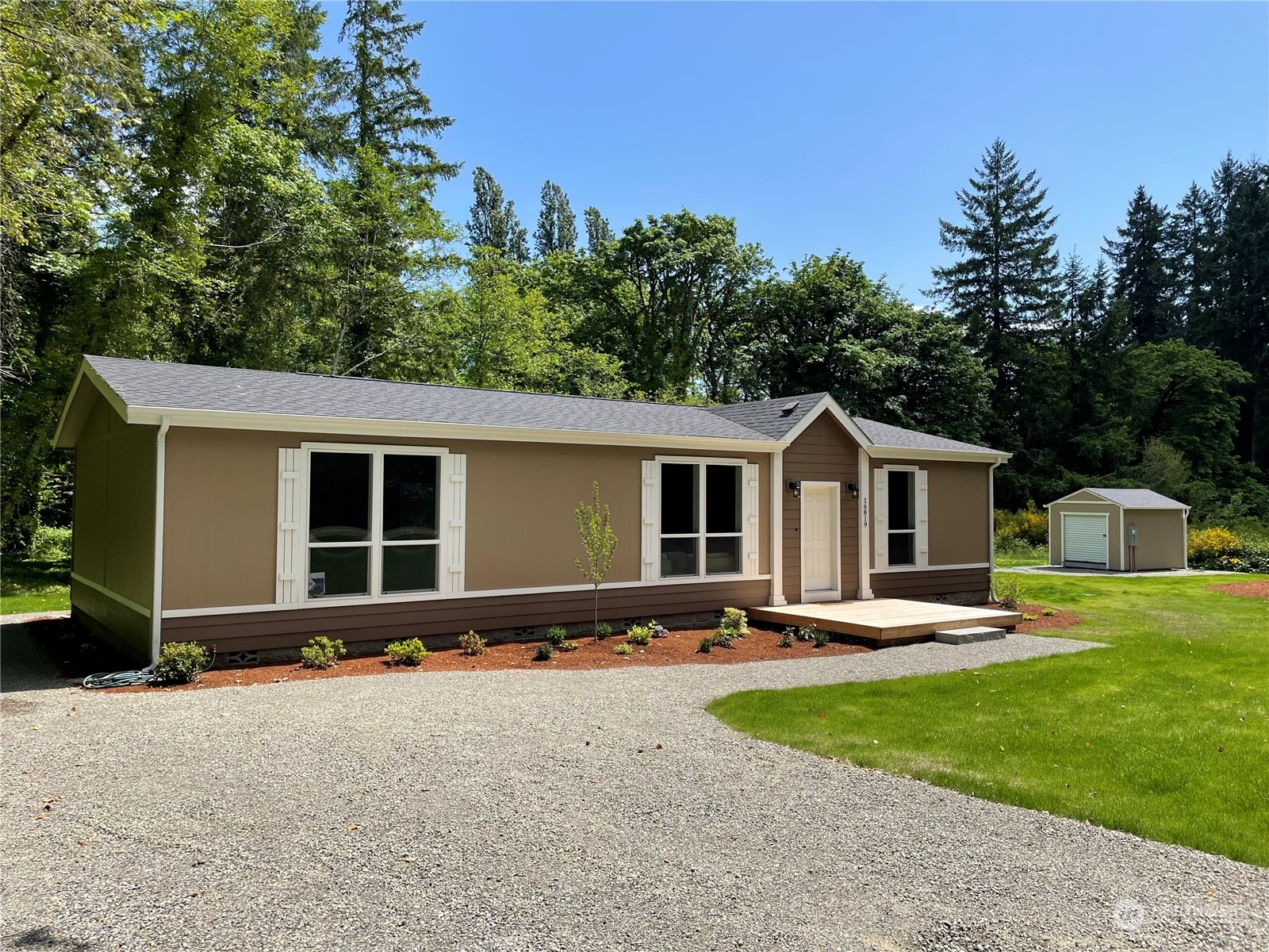 16819 Erickson Road Southwest Longbranch, WA 98351 - Photo 1 of 15 a front view of house with yard and trees in the background