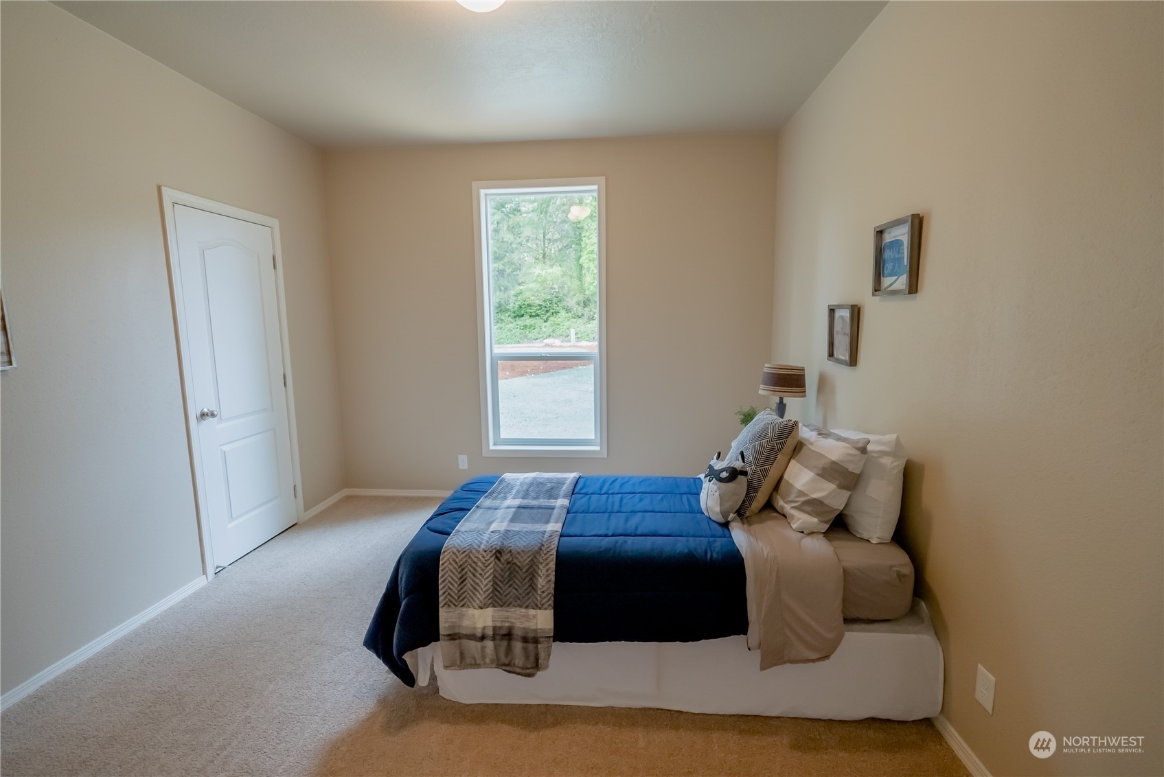 16819 Erickson Road Southwest Longbranch, WA 98351 - Photo 11 of 15 a bedroom with a bed and window
