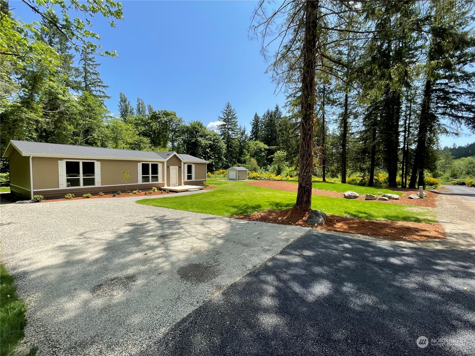 16819 Erickson Road Southwest Longbranch, WA 98351 - Photo 2 of 15 a view of a house with a big yard and large trees