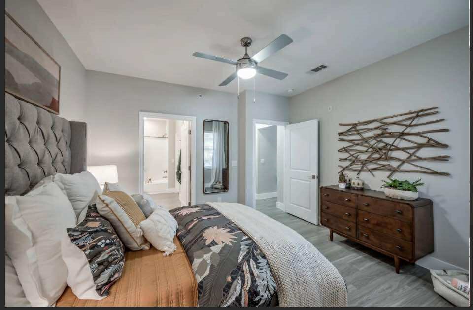 529 Barker-Clodine Road, Unit JUNIPER Houston, TX 77094 - Photo 14 of 21 a spacious bedroom with a bed and ceiling fan