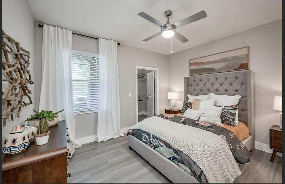 529 Barker-Clodine Road, Unit JUNIPER Houston, TX 77094 - Photo 19 of 21 a bedroom with a large bed and a potted plant