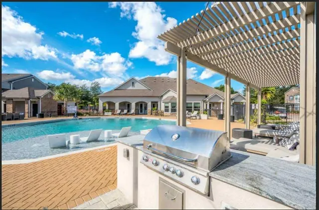 a view of a house with backyard and sitting area