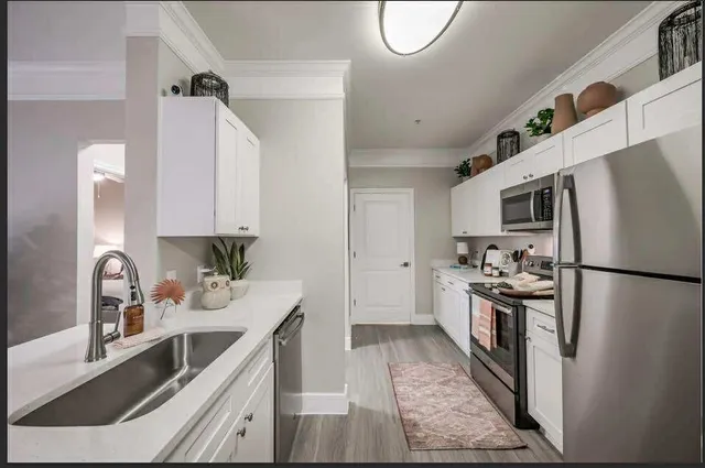 a kitchen with a refrigerator sink and stainless steel appliances