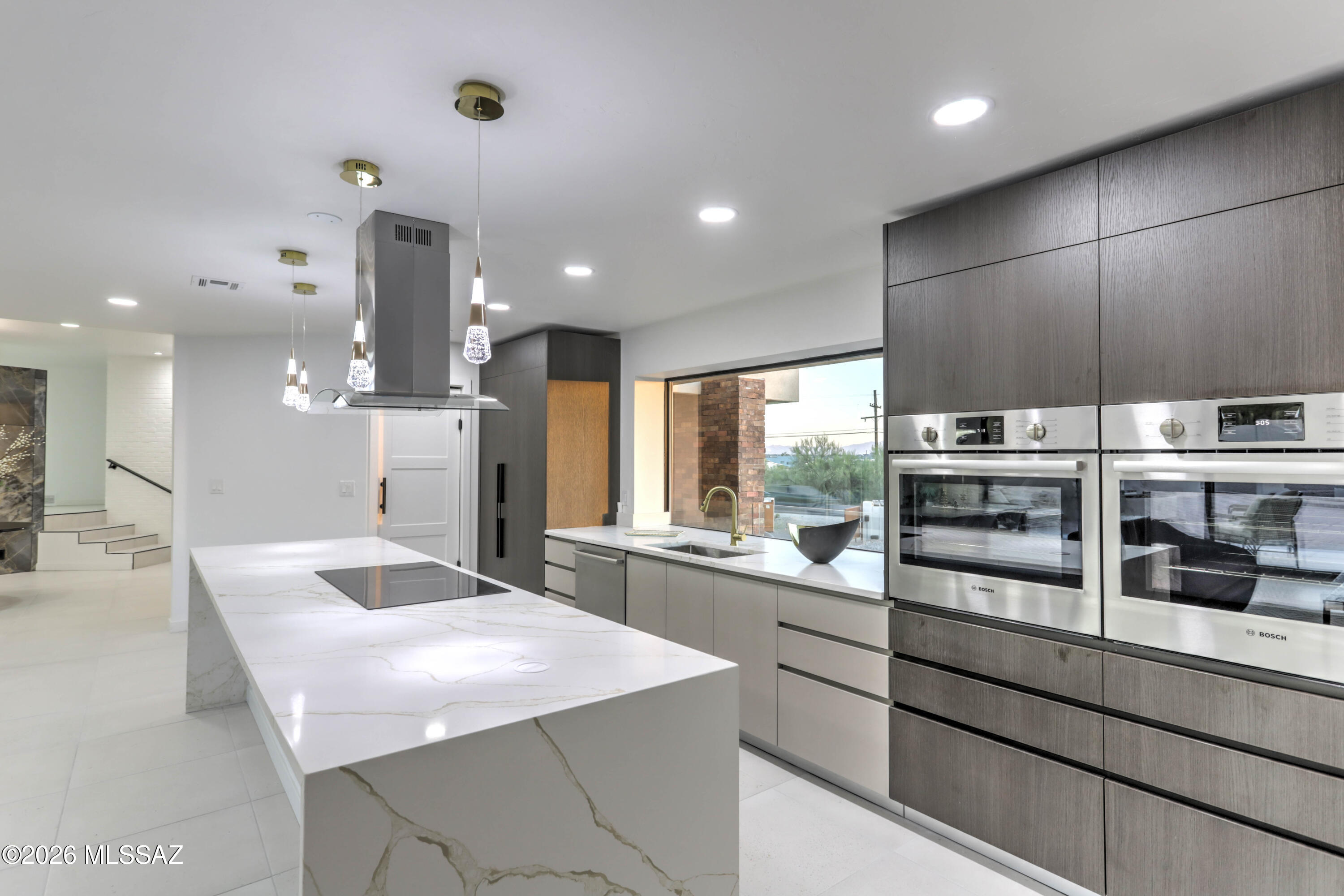 4939 East River Road Tucson, AZ 85718 - Photo 6 of 29 a kitchen with stainless steel appliances kitchen island granite countertop a table and chairs