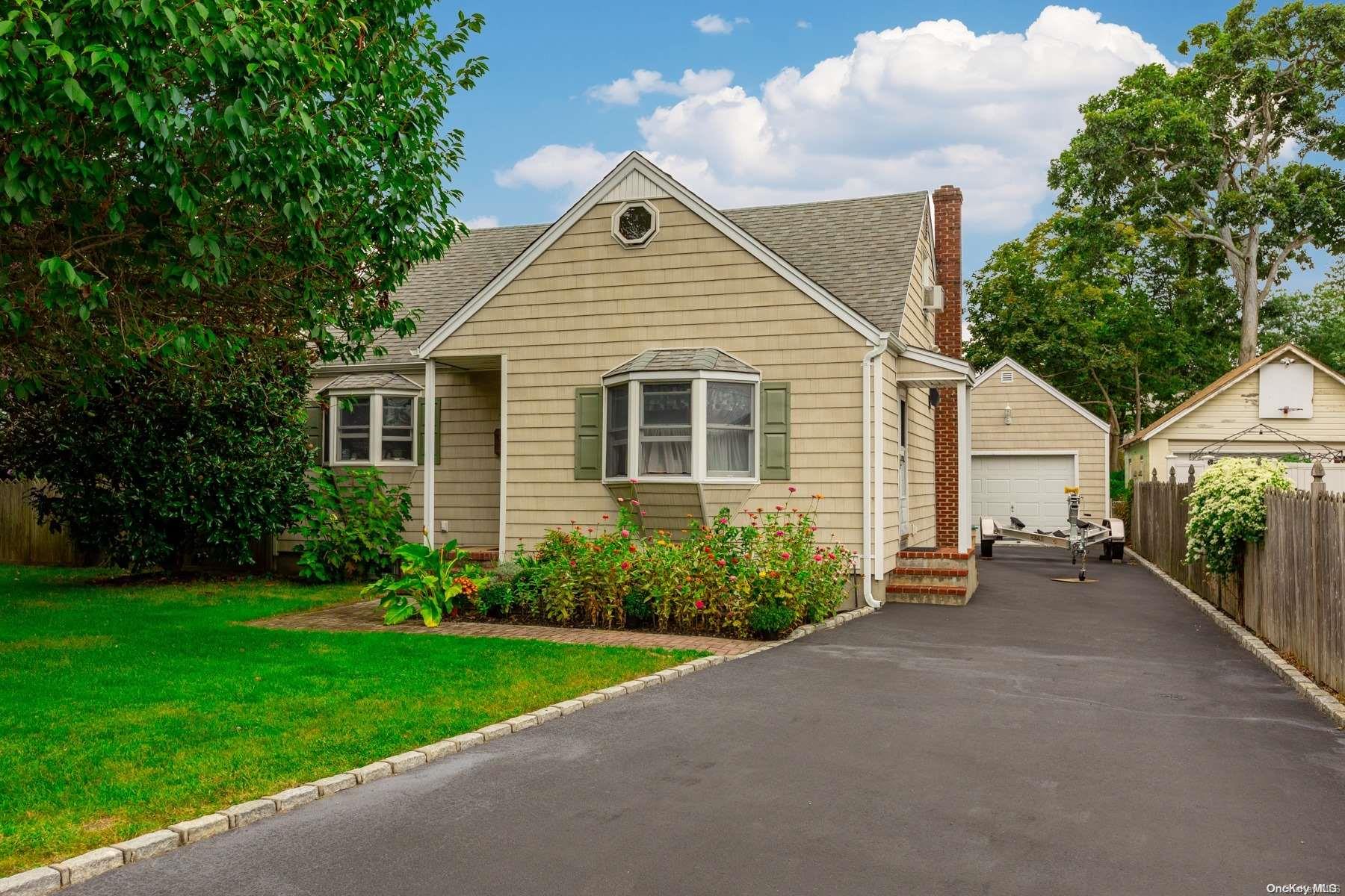 a view of a house with a yard and potted plants