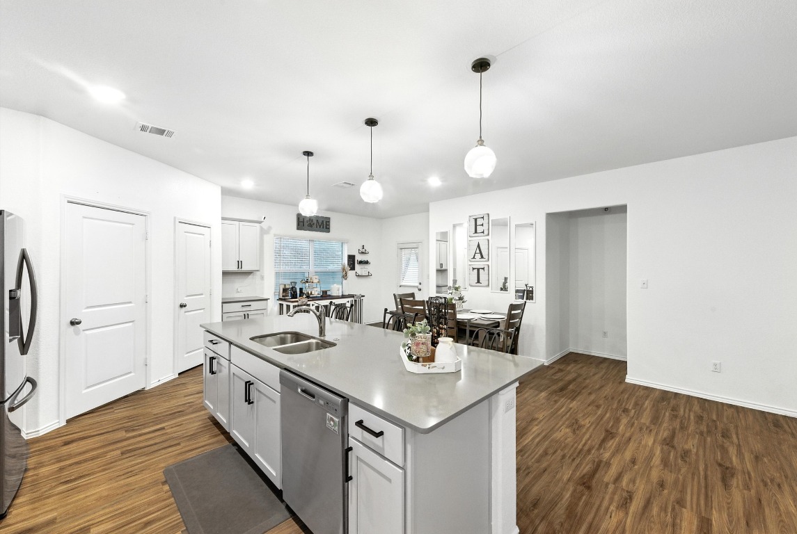 112 Cherry Ridge Road Georgetown, TX 78628 - Photo 15 of 35 a kitchen with a sink a stove a refrigerator and white cabinets