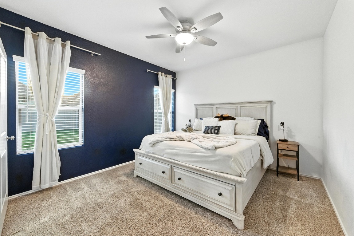 112 Cherry Ridge Road Georgetown, TX 78628 - Photo 18 of 35 a bedroom with a bed and a ceiling fan