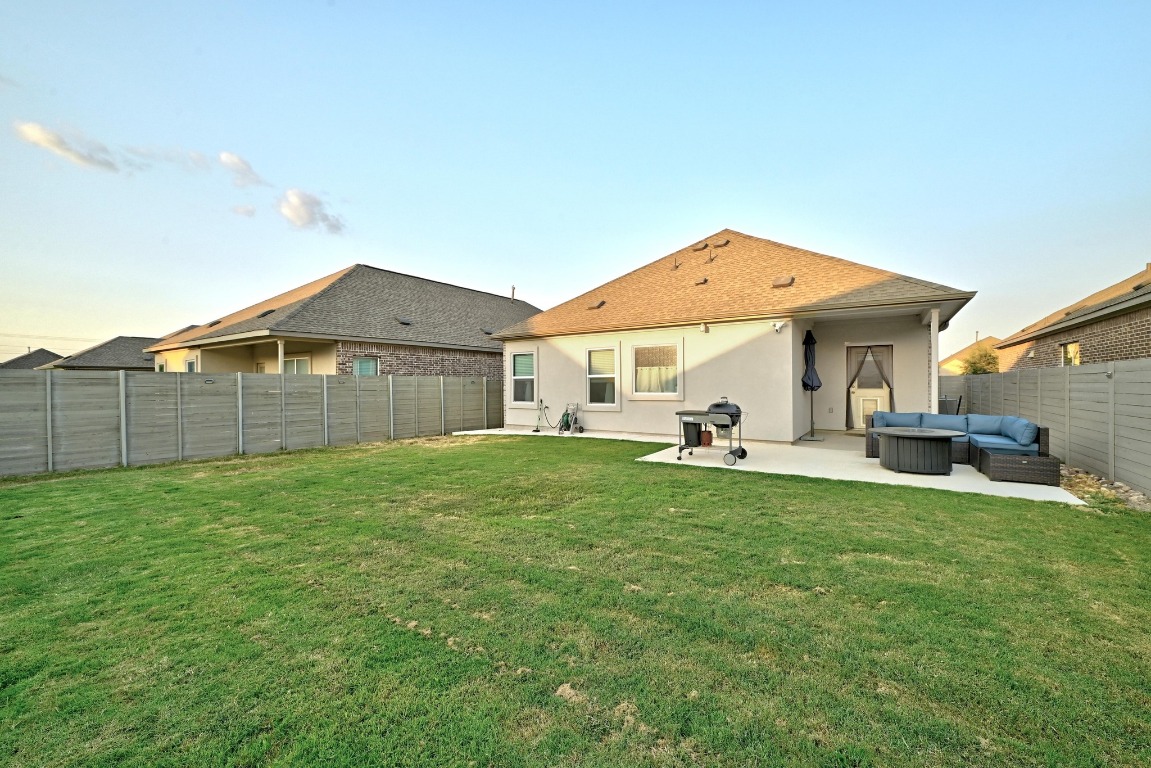 112 Cherry Ridge Road Georgetown, TX 78628 - Photo 26 of 35 a view of a house with a backyard and a patio