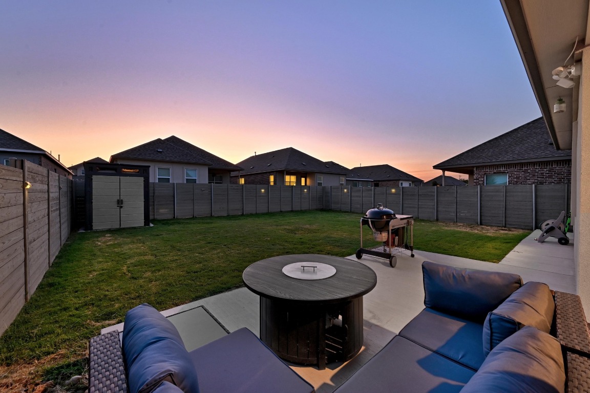 112 Cherry Ridge Road Georgetown, TX 78628 - Photo 30 of 35 Fenced backyard with a patio, a grill, and outdoor lounge area