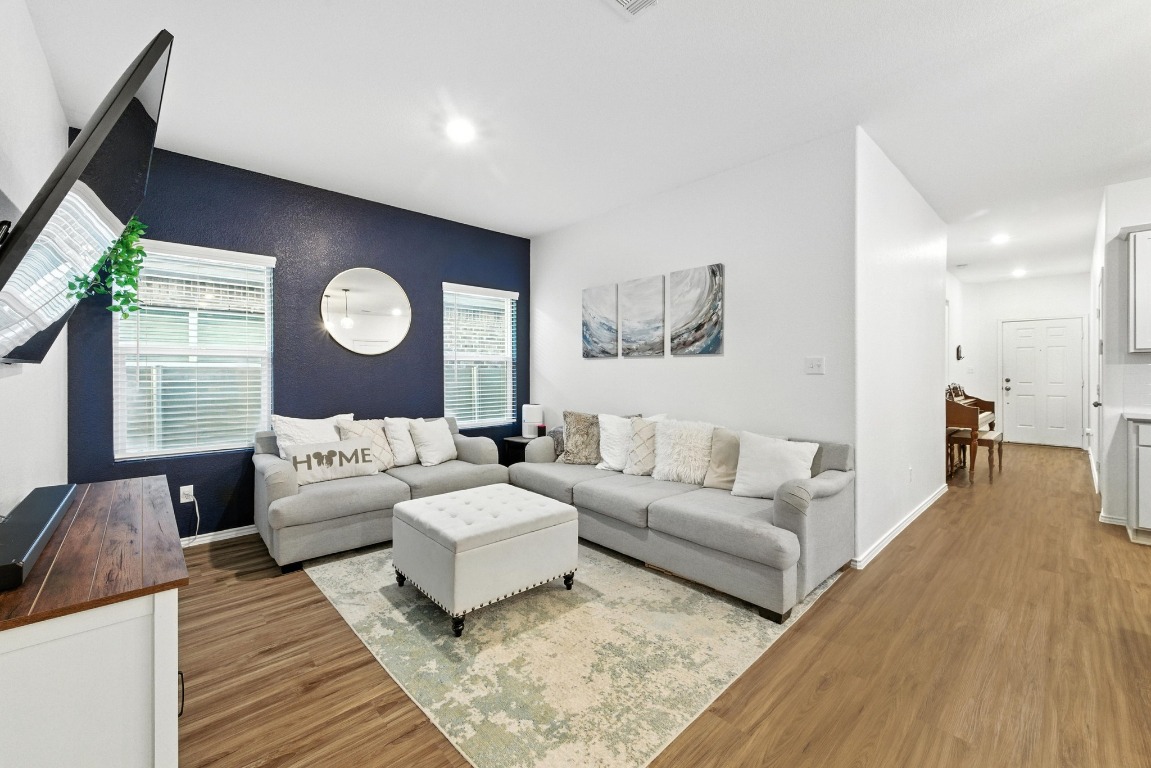 112 Cherry Ridge Road Georgetown, TX 78628 - Photo 7 of 35 a living room with couches and a large mirror with wooden floor
