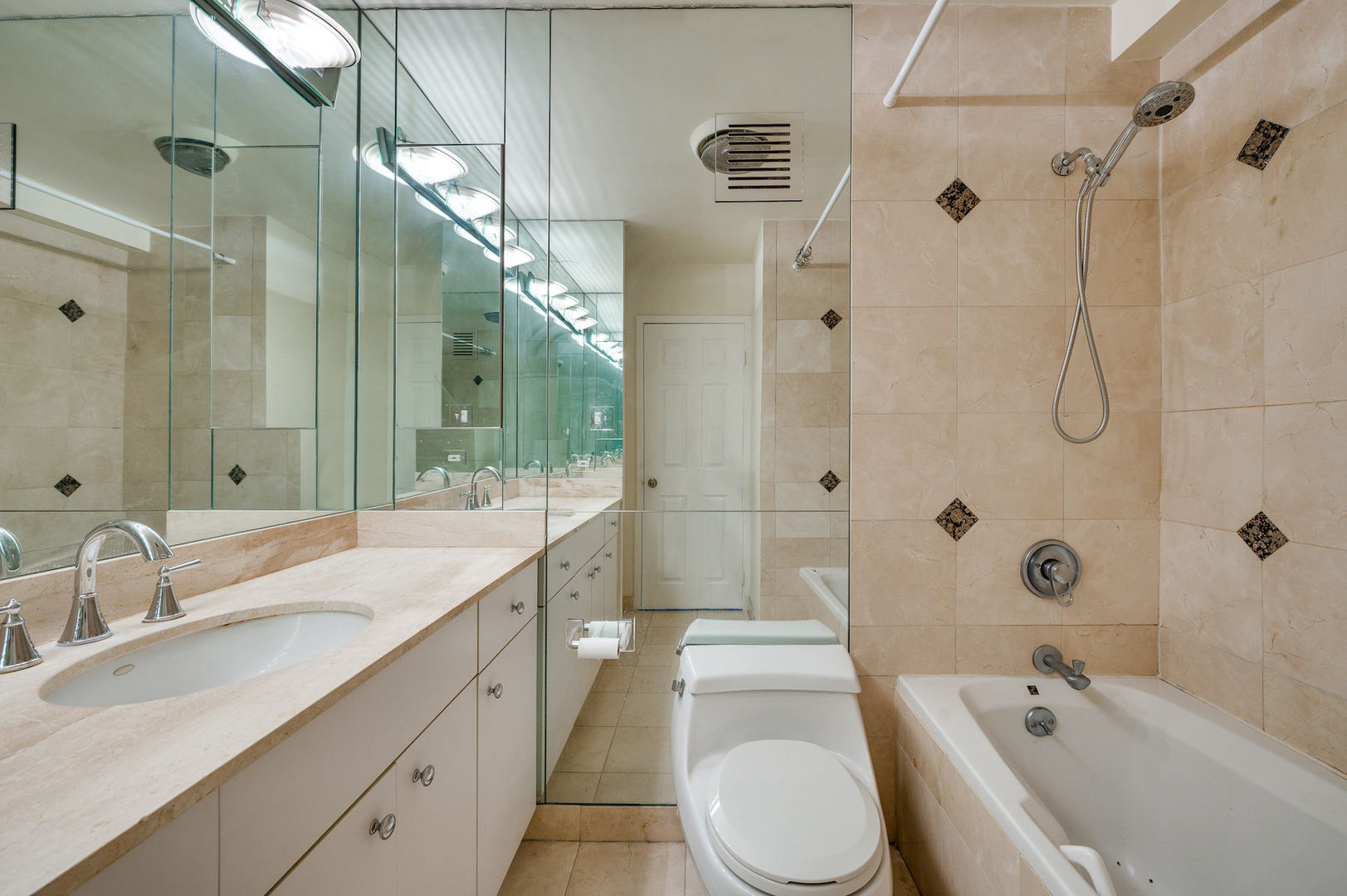 111 East Chestnut Street, Unit 37F Chicago, IL 60611 - Photo 13 of 23 a bathroom with a granite countertop sink toilet a shower and a bathtub