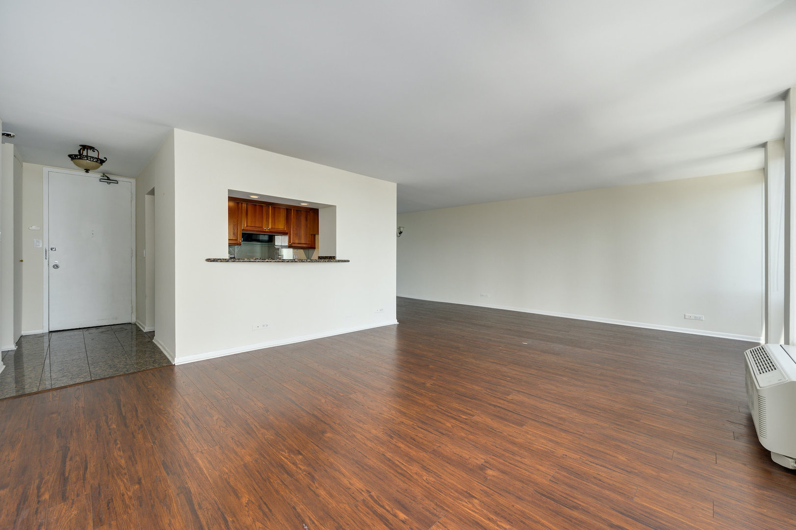111 East Chestnut Street, Unit 37F Chicago, IL 60611 - Photo 4 of 23 a view of a big room with wooden floor and a ceiling fan