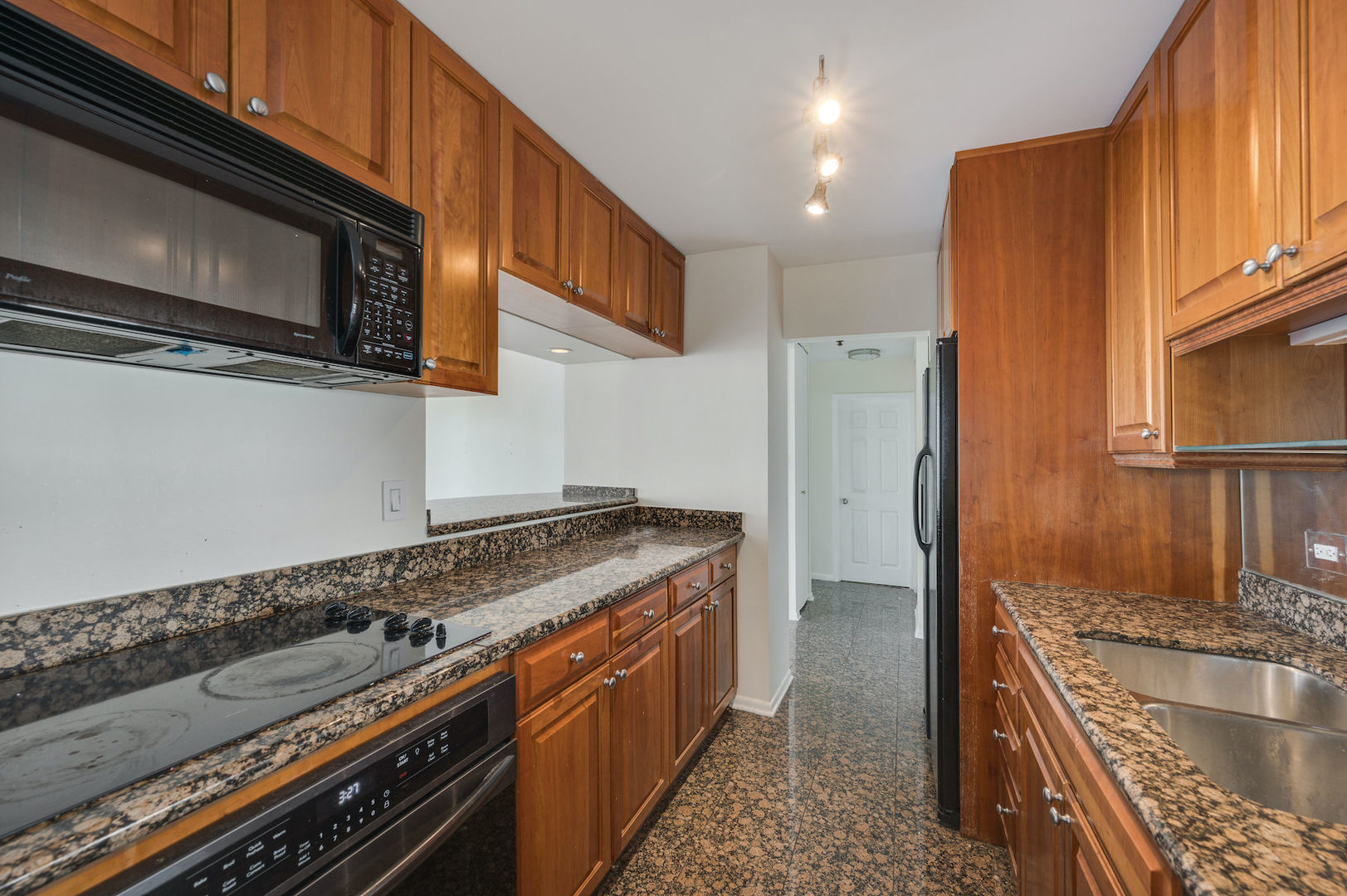 111 East Chestnut Street, Unit 37F Chicago, IL 60611 - Photo 6 of 23 a kitchen with stainless steel appliances granite countertop a stove a sink and a microwave