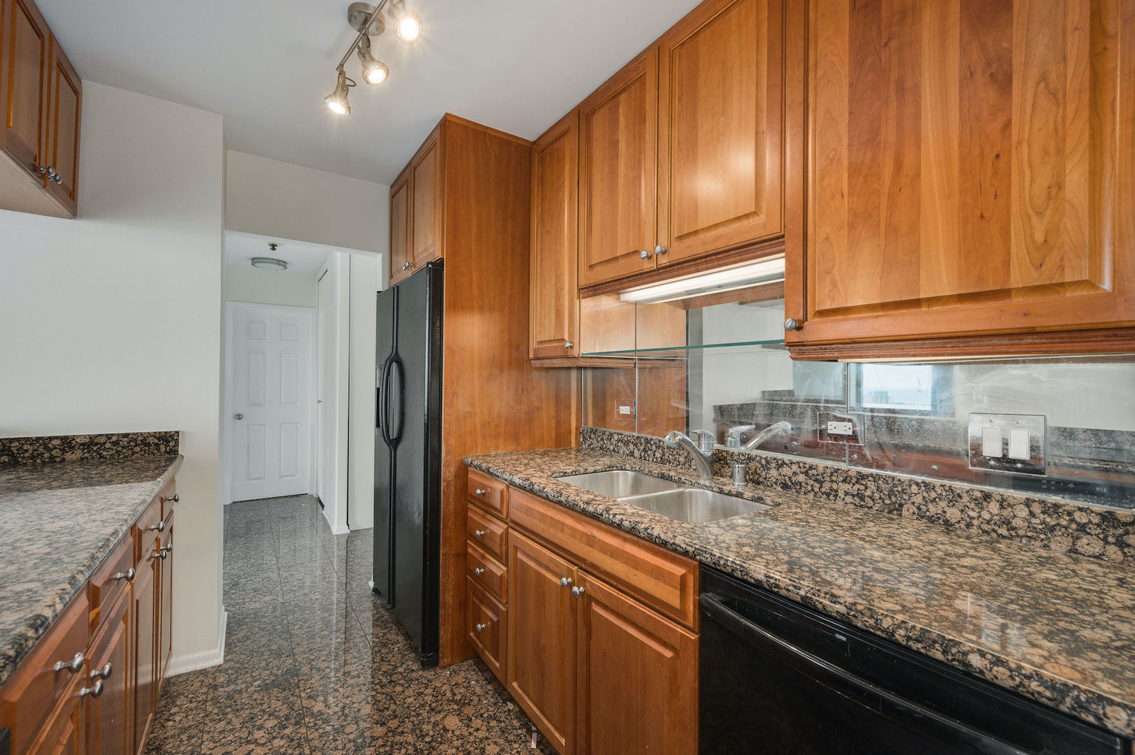 111 East Chestnut Street, Unit 37F Chicago, IL 60611 - Photo 7 of 23 a kitchen with granite countertop stainless steel appliances a sink stove and refrigerator