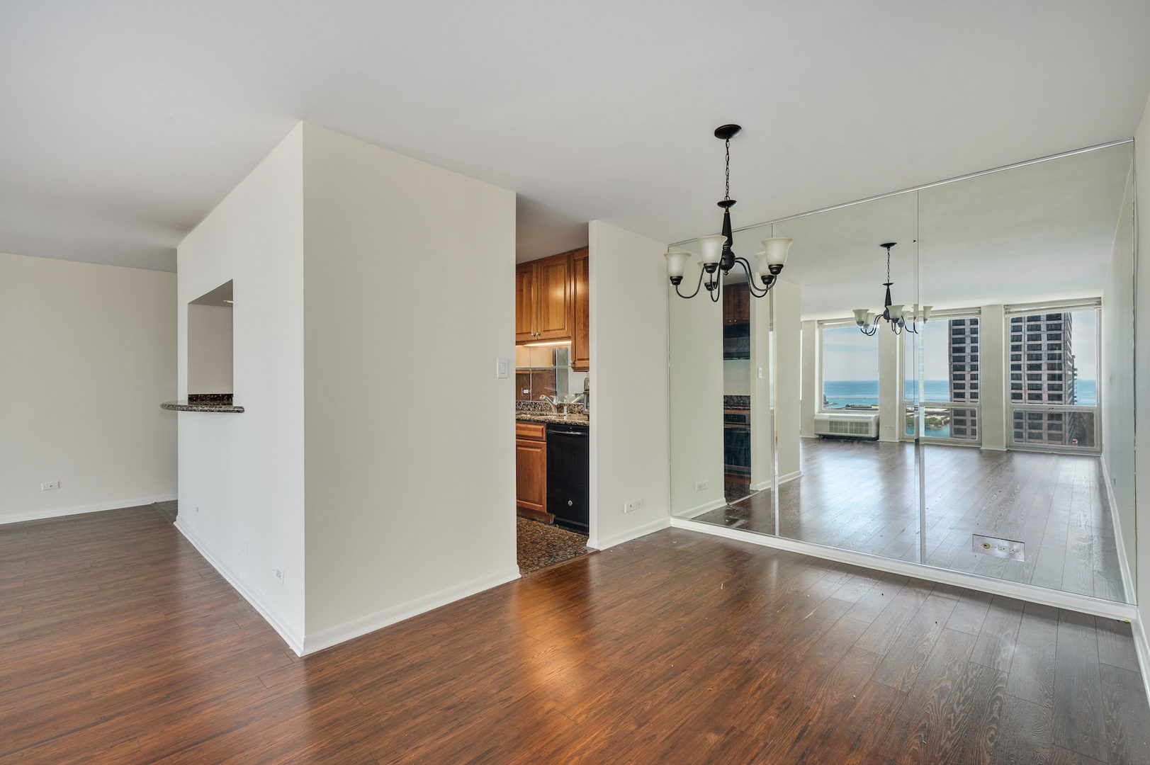 111 East Chestnut Street, Unit 37F Chicago, IL 60611 - Photo 10 of 23 a view of a livingroom with wooden floor and a ceiling fan