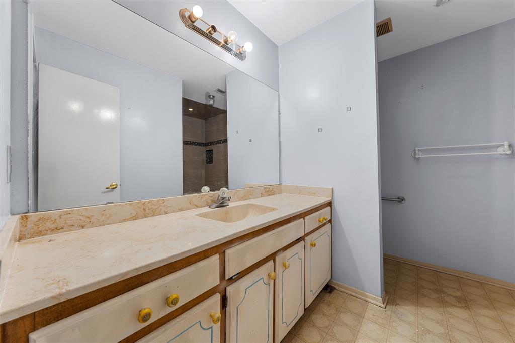 413 Texas Avenue Hewitt, TX 76643 - Photo 13 of 26 Bathroom with vanity and tiled shower