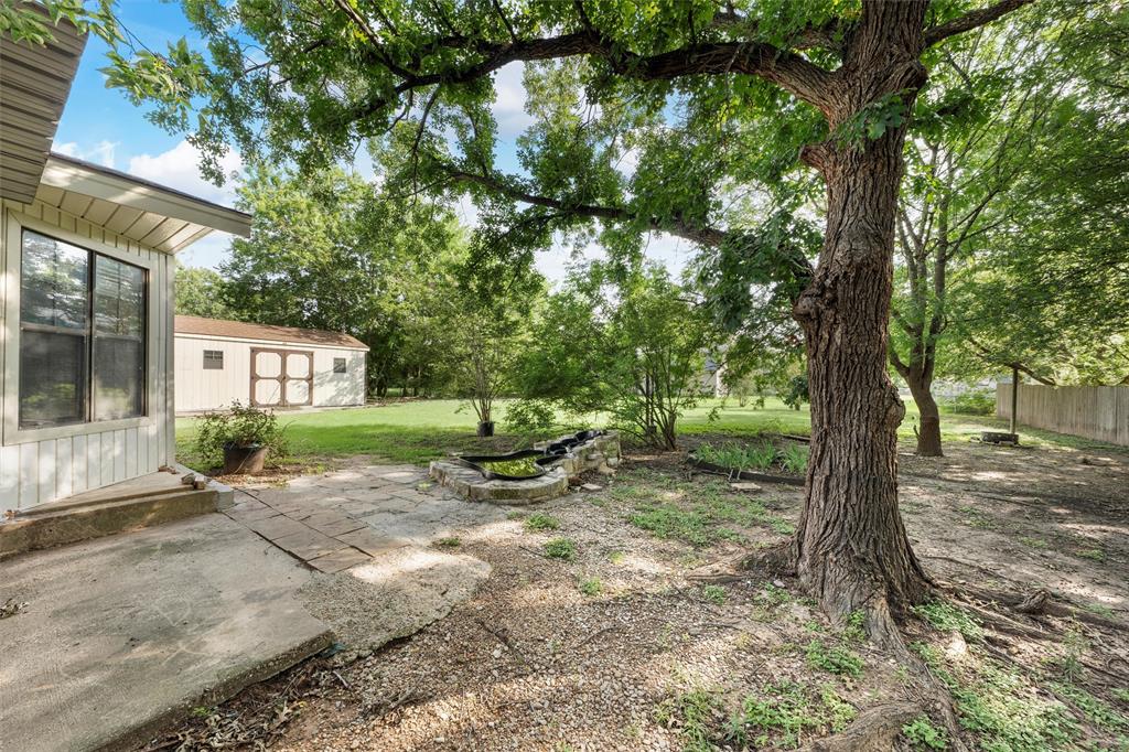 413 Texas Avenue Hewitt, TX 76643 - Photo 24 of 26 View of grassy yard with an outbuilding and a patio area
