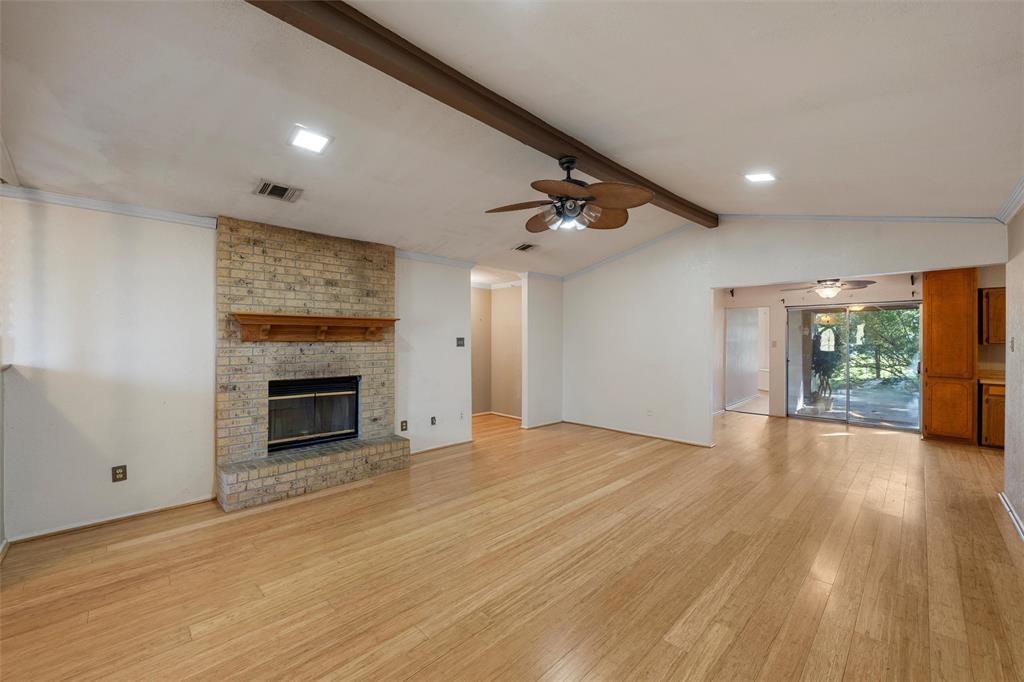 413 Texas Avenue Hewitt, TX 76643 - Photo 4 of 26 Unfurnished living room featuring ceiling fan, light wood finished floors, and a fireplace