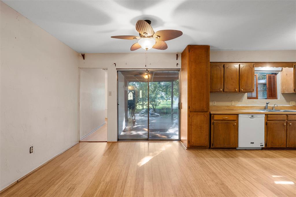 413 Texas Avenue Hewitt, TX 76643 - Photo 6 of 26 Kitchen featuring brown cabinets, light wood finished floors, white dishwasher, light countertops, and plenty of natural light