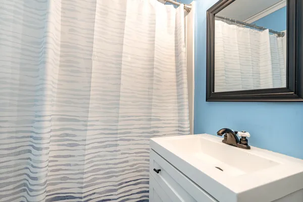 a bathroom with a sink and a window