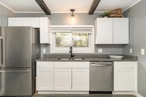 a kitchen with appliances cabinets and a counter top space