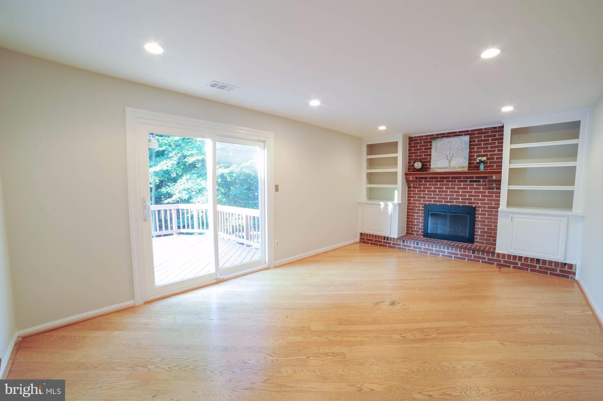 8303 Lindside Way Springfield, VA 22153 - Photo 11 of 30 Family Room with gas fireplace and door to deck