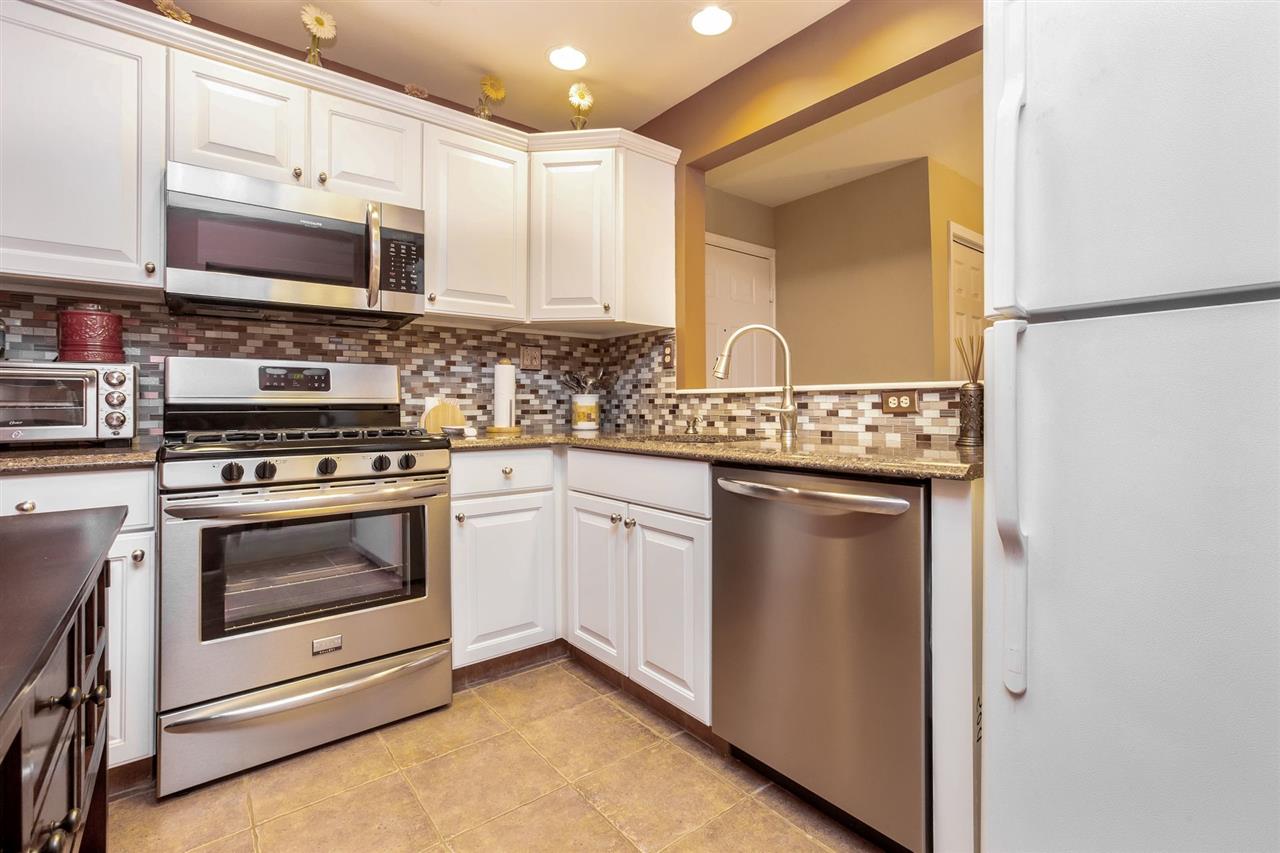 131 Clinton Place, Unit 204 Hackensack, NJ 07601 - Photo 1 of 1 a kitchen with stainless steel appliances granite countertop a stove and a microwave