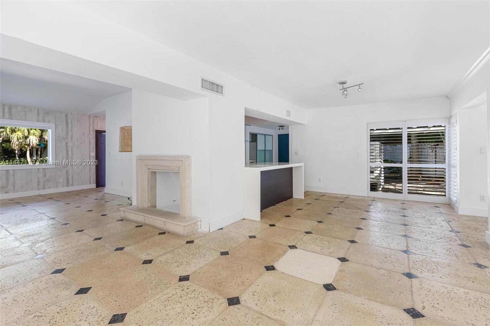 325 Gulf Road Key Biscayne, FL 33149 - Photo 11 of 20 a view of a livingroom with wooden floor and kitchen space
