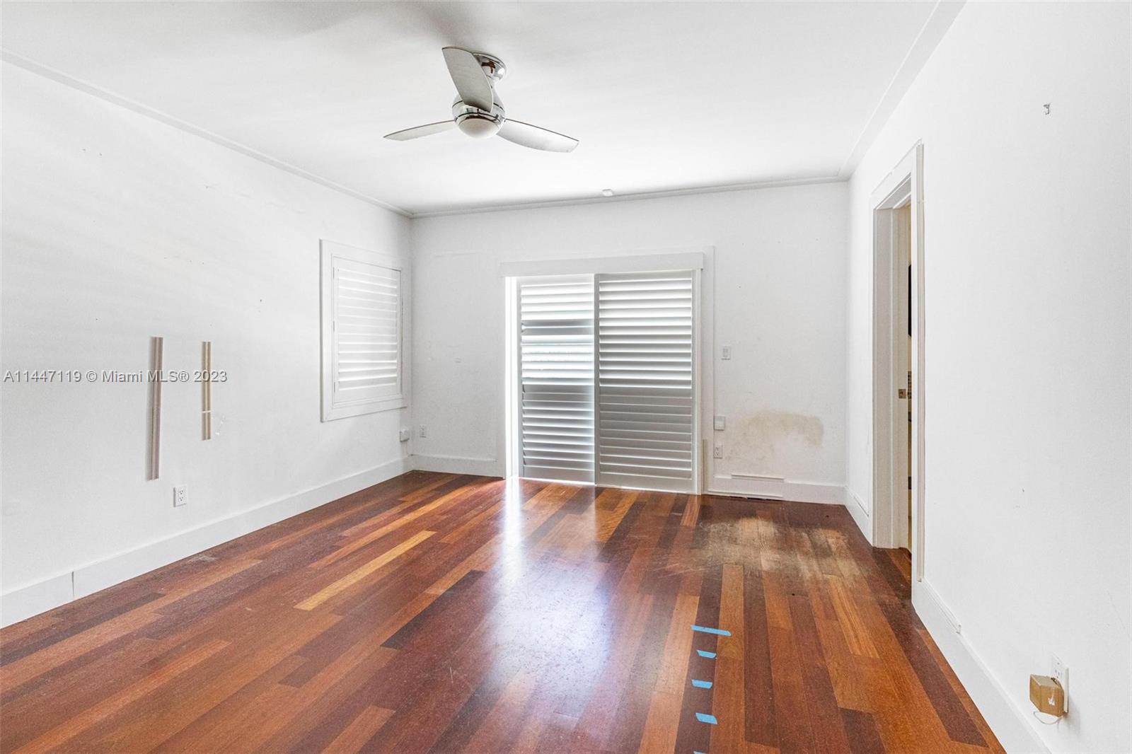 325 Gulf Road Key Biscayne, FL 33149 - Photo 15 of 20 a view of an empty room with wooden floor and a window