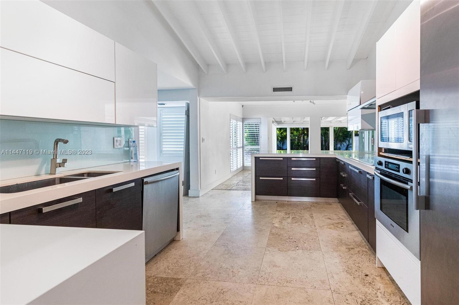 325 Gulf Road Key Biscayne, FL 33149 - Photo 16 of 20 a large kitchen with a large counter top stainless steel appliances and cabinets