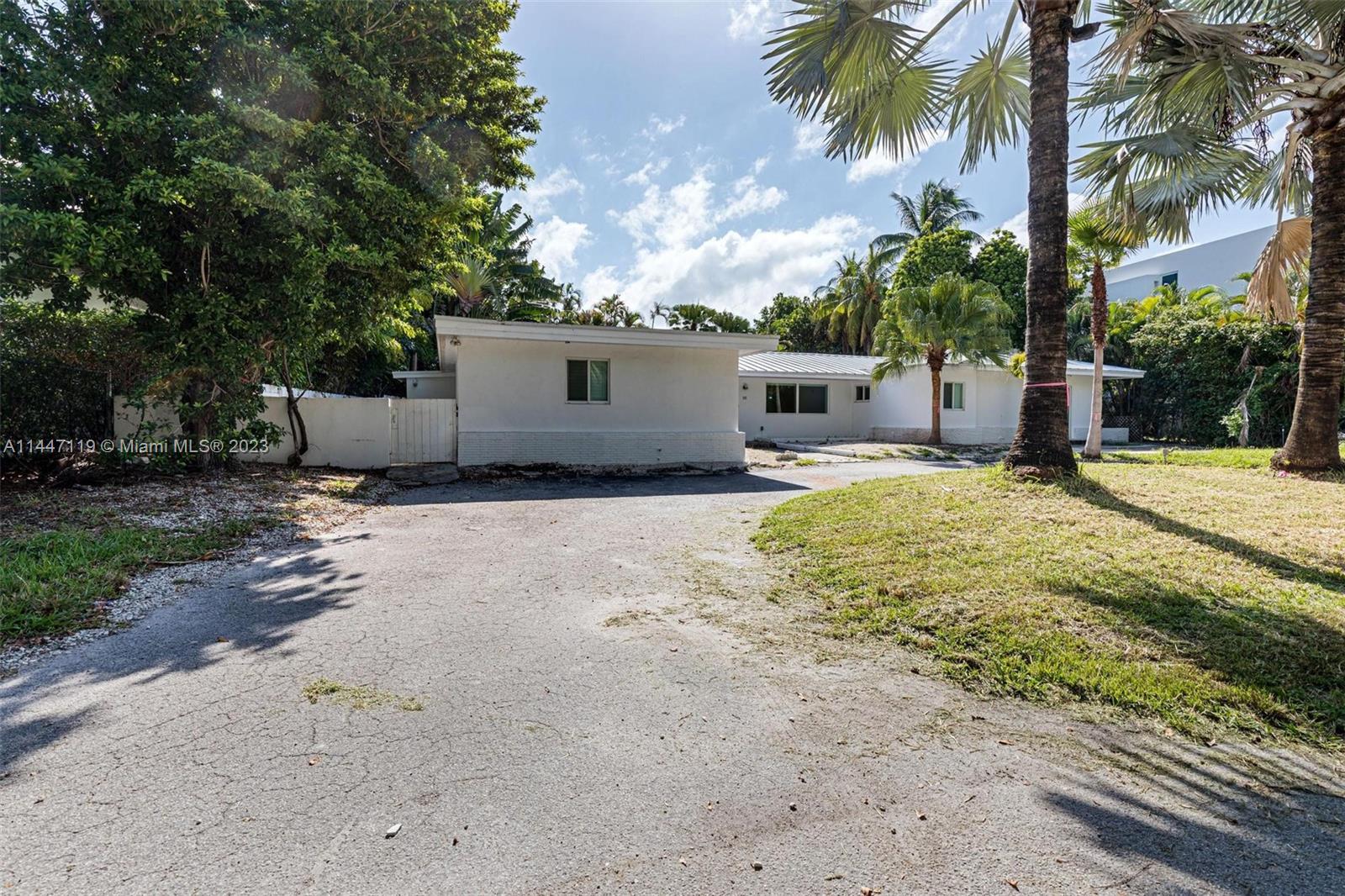 325 Gulf Road Key Biscayne, FL 33149 - Photo 3 of 20 a view of a house with a yard and large tree