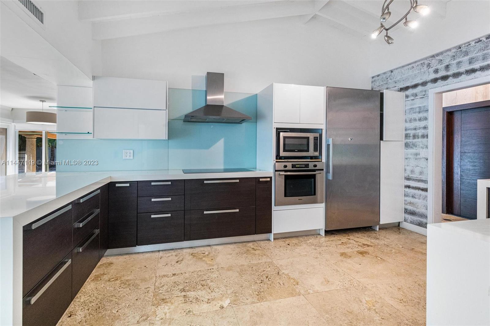325 Gulf Road Key Biscayne, FL 33149 - Photo 6 of 20 a kitchen with stainless steel appliances granite countertop a refrigerator and a sink