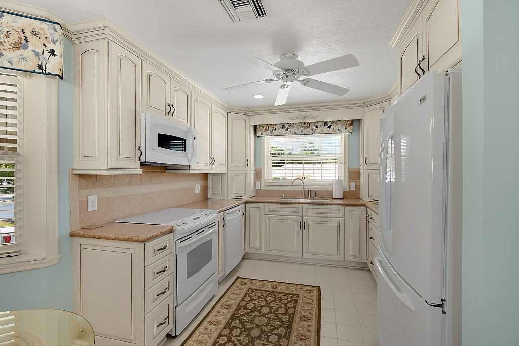 a kitchen with stainless steel appliances a white cabinets and sink