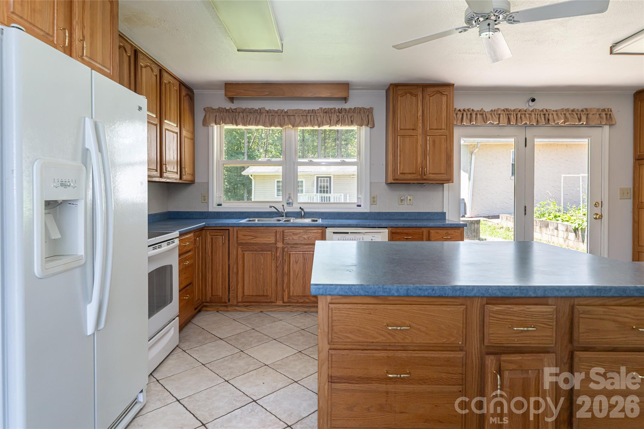2800 Coxe Road Tryon, NC 28782 - Photo 8 of 40 a kitchen with stainless steel appliances granite countertop a sink a stove and a refrigerator