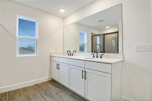 a bathroom with 2 sink and a mirror