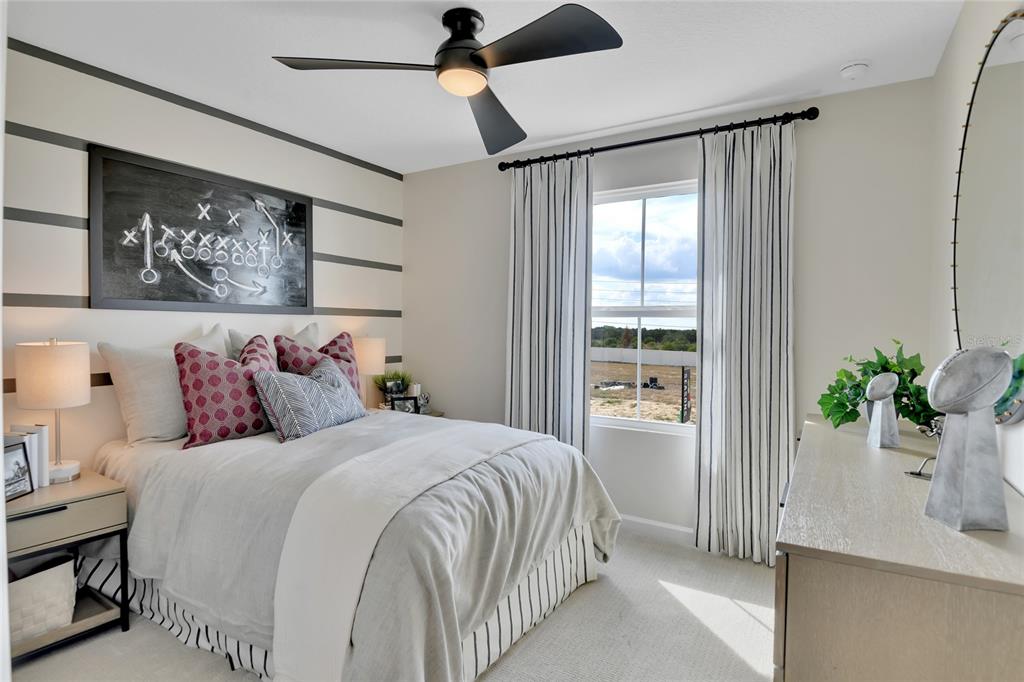 176 Blue Star Court Tavares, FL 32778 - Photo 20 of 21 a bedroom with a large bed and a potted plant