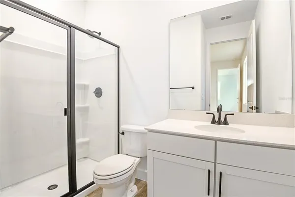 a bathroom with a sink toilet and shower