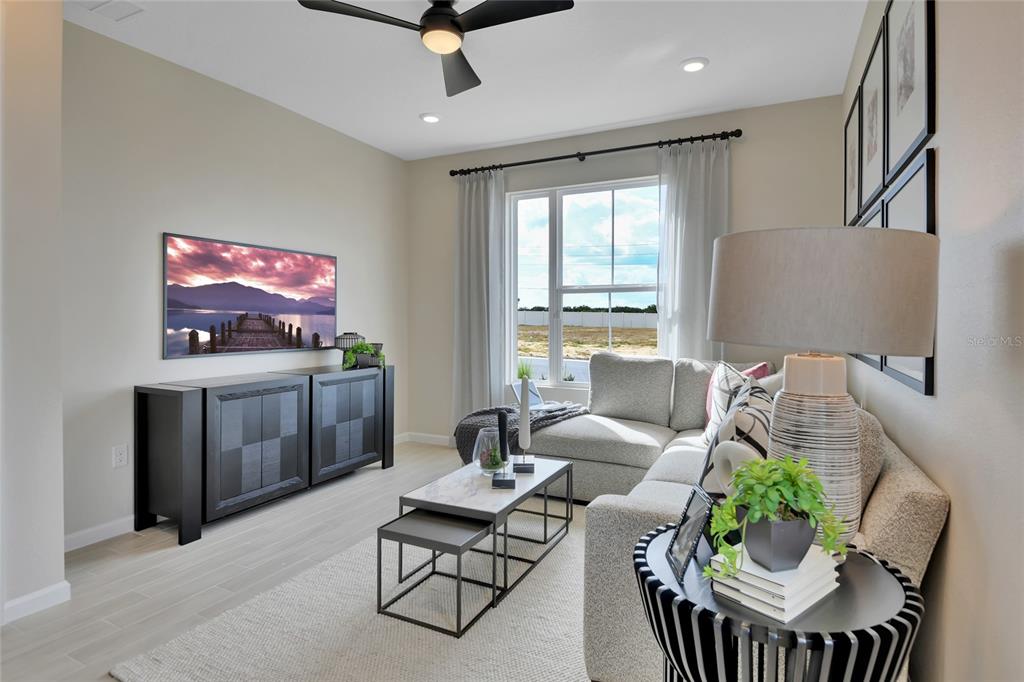 176 Blue Star Court Tavares, FL 32778 - Photo 8 of 21 a living room with furniture a dining table and a flat screen tv