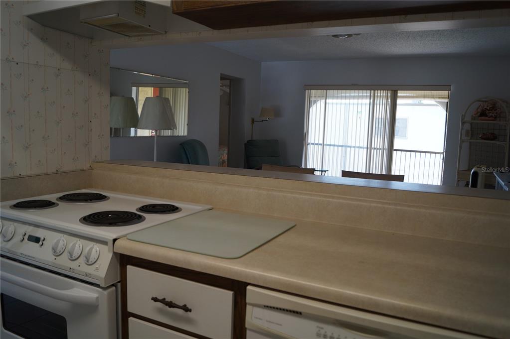 7701 Starkey Road, Unit 408 Seminole, FL 33777 - Photo 13 of 28 a kitchen with a stove and a cabinet