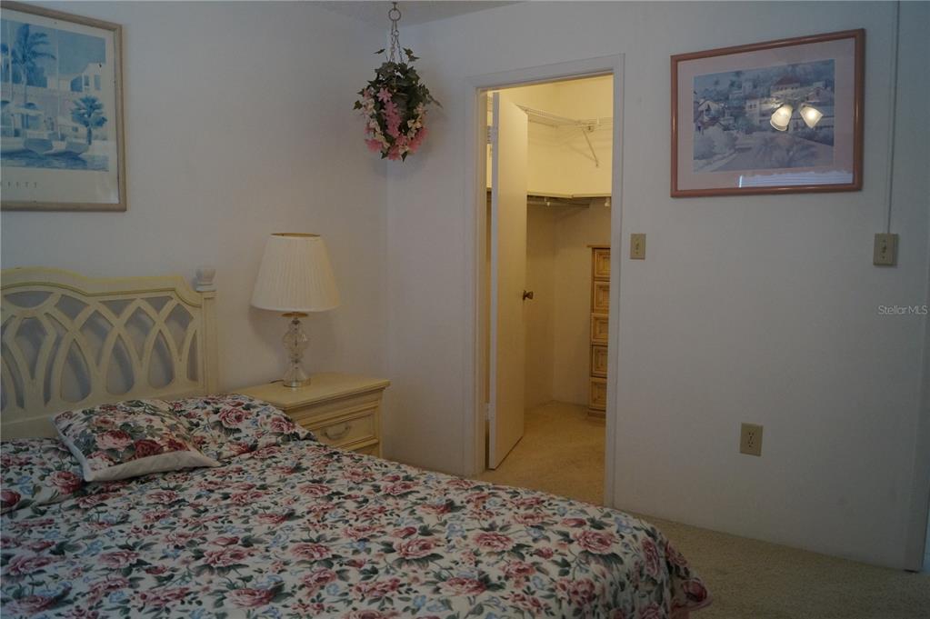 7701 Starkey Road, Unit 408 Seminole, FL 33777 - Photo 16 of 28 a bedroom with a bed and a painting on the wall