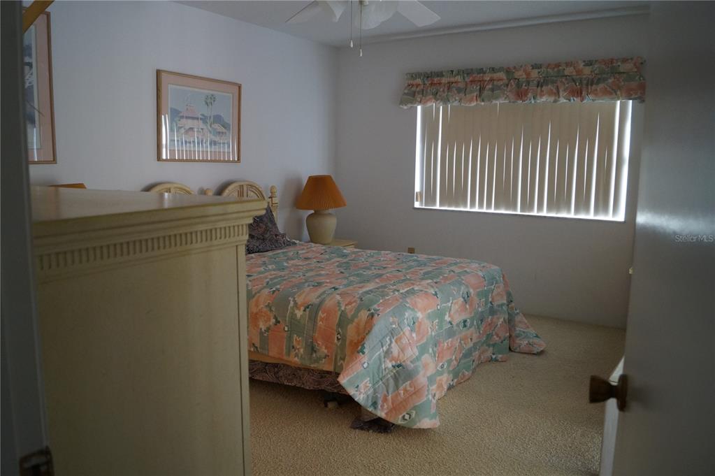 7701 Starkey Road, Unit 408 Seminole, FL 33777 - Photo 20 of 28 a bedroom with a bed and a window