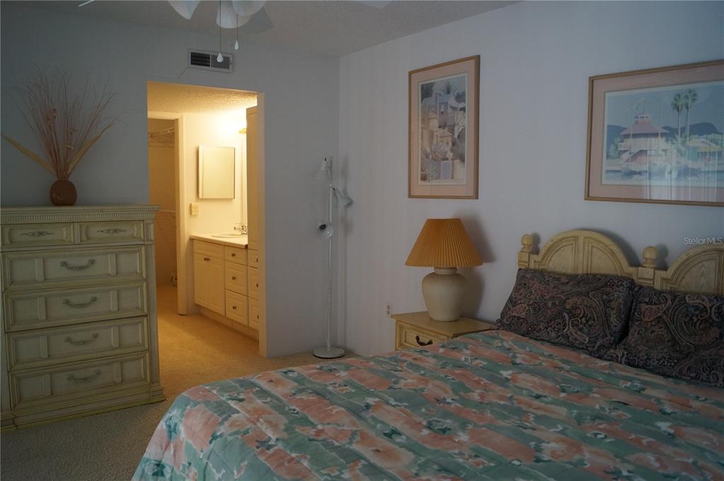 7701 Starkey Road, Unit 408 Seminole, FL 33777 - Photo 21 of 28 a bedroom with a bed and a dresser